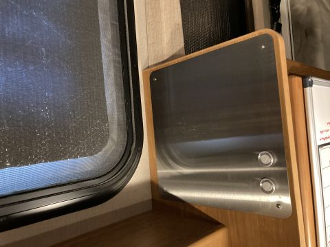2015 Ford F-550 - Close-up of a vehicle's interior, showing a window and a metallic panel with two circular buttons.