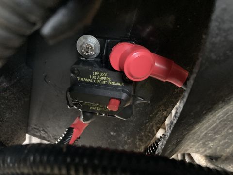 2015 Ford F-550 - Close-up of a 100 Ampere thermal circuit breaker, labeled 'Ignition Prot Waterproof'.