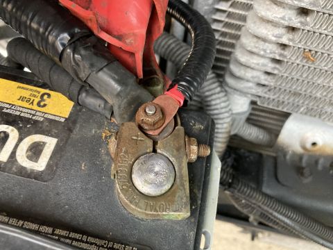 2015 Ford F-550 - A close-up view of a vehicle's battery terminal, showing wiring and corrosion.