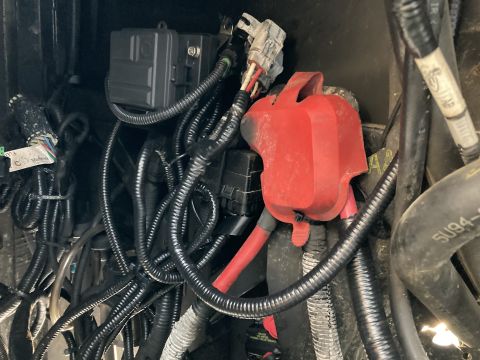 2015 Ford F-550 - Close-up view of a vehicle's electrical system, showing various wires, fuse boxes, and battery connections.