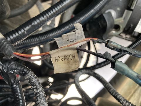 2015 Ford F-550 - Close-up of engine wiring, showing a label that reads "A/C SWITCH" and other electrical components.