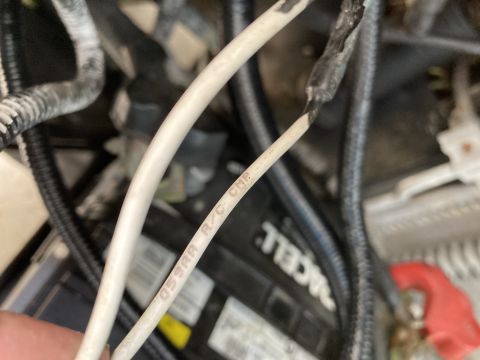 2015 Ford F-550 - Detail of engine compartment wiring, showing a section of the harness with printed text.
