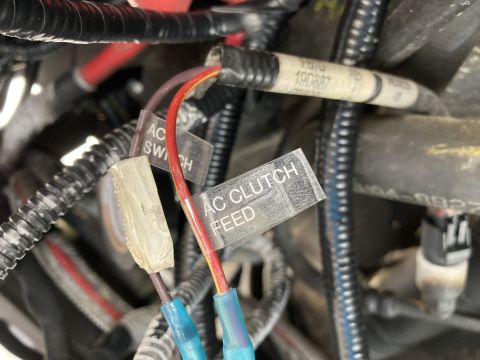 2015 Ford F-550 - Close-up of engine wiring harness with labels indicating AC SWITCH and AC CLUTCH FEED.