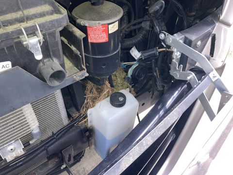 2015 Ford F-550 - A bird has built a nest in the engine compartment, amongst the vehicle's components.