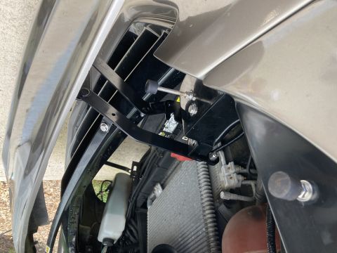 2015 Ford F-550 - Hood bracket assembly shown attached to the vehicle's front end.