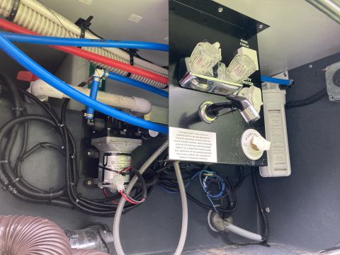 2015 Ford F-550 - Close-up of an RV's water system components, including a pump and filter.
