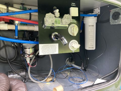 2015 Ford F-550 - Close-up view of plumbing and water system components inside an RV.