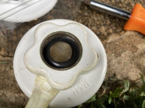 2015 Ford F-550 - A close-up view of a white faucet part a mesh screen and an R&B logo, with a screwdriver visible in the background.