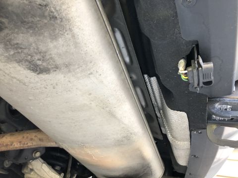 2019 Ford Everest - Close-up view of the exhaust system and tow hitch components on the underside of a vehicle.