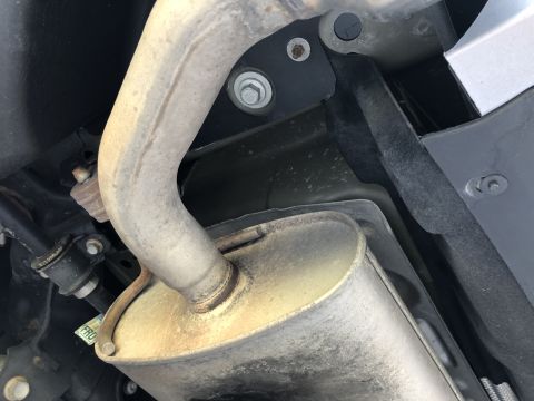 2019 Ford Everest - Close-up of a vehicle's undercarriage, showing the exhaust system and a tow hitch bracket.