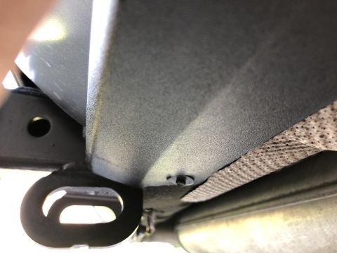 2019 Ford Everest - Close-up view of a vehicle's undercarriage, showing a tow hook and exhaust system components.