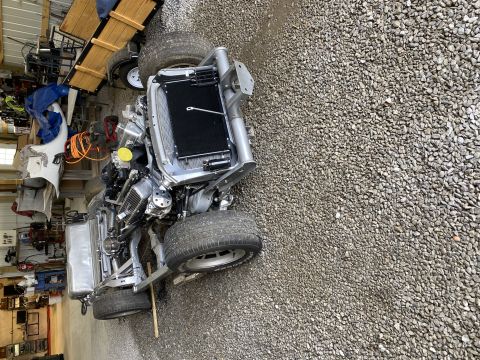 1976 Chevrolet Corvette - Car chassis and engine assembly shown, with a trailer in the background.