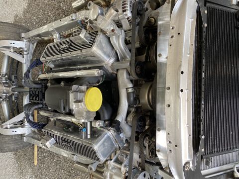 1976 Chevrolet Corvette - Close-up view of an engine and its associated components, including a radiator and part of the chassis.