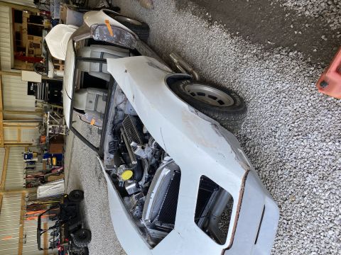 1976 Chevrolet Corvette - This 1976 Chevrolet Corvette is in a state of restoration, with its engine bay open and bodywork in progress.