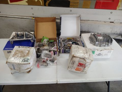 1996 Ford Bronco - Various vehicle parts are laid out on a table, some in boxes and others wrapped in protective material.