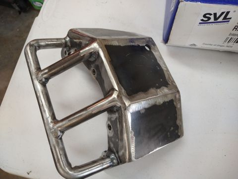 1996 Ford Bronco - A custom metal part, possibly a bumper or skid plate, is shown with visible welds and a protective tubular guard.
