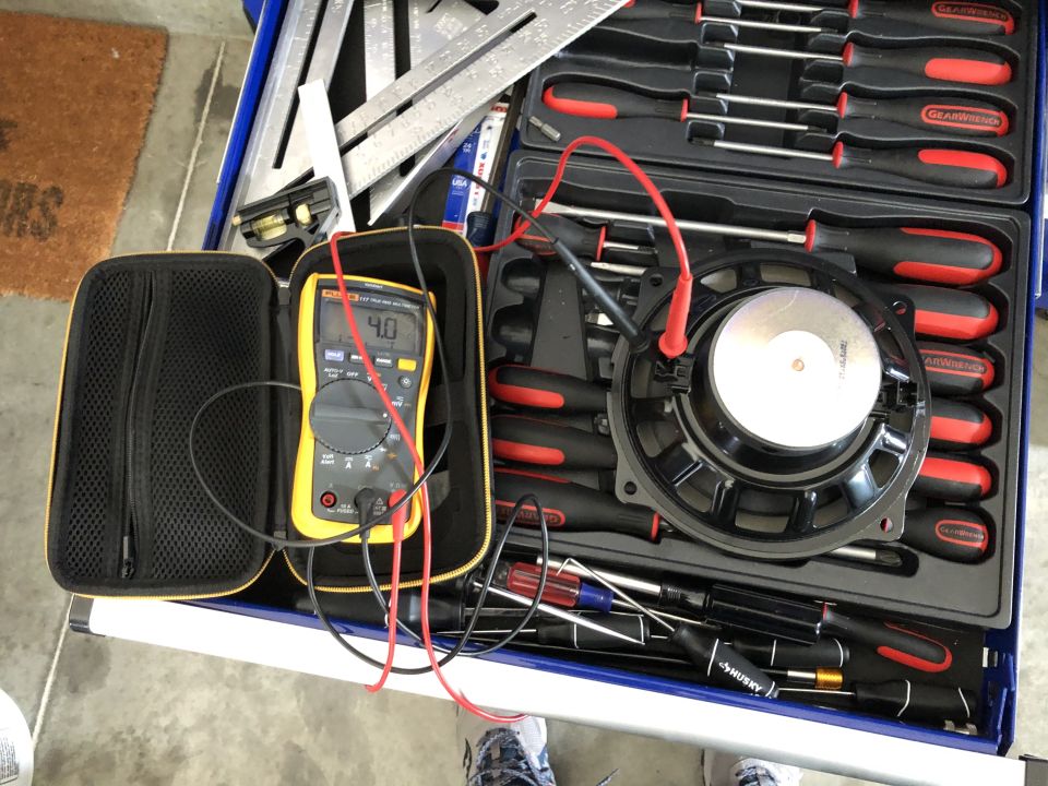 Speaker with multimeter and various tools in a toolbox