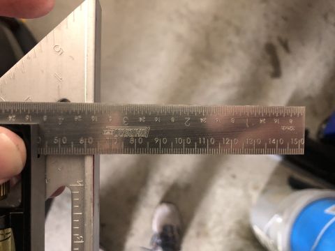 2019 Ford Everest - A combination square and ruler are used to measure an object, showing precise markings.