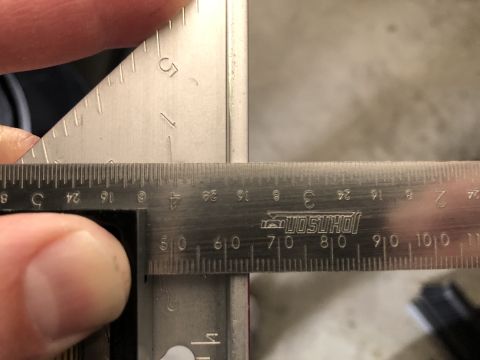 2019 Ford Everest - A metal ruler and square are used to measure an object's dimensions.