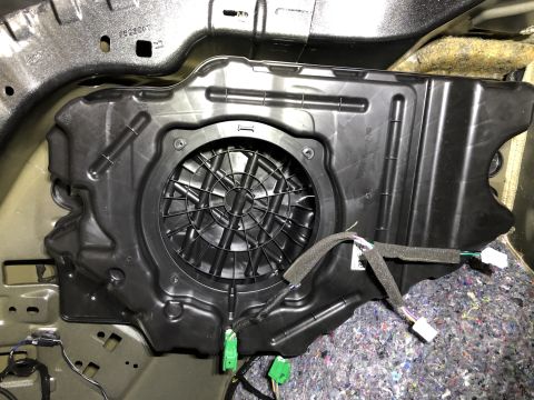 2019 Ford Everest - Close-up of a car's subwoofer enclosure, showing wiring and mounting points.