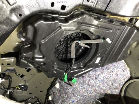 2019 Ford Everest - Subwoofer housing removed from car door panel, revealing insulation and wiring.