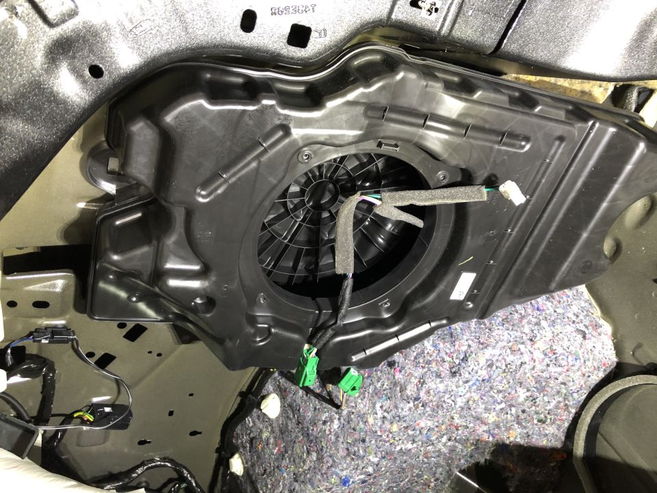 Subwoofer housing removed from car door panel