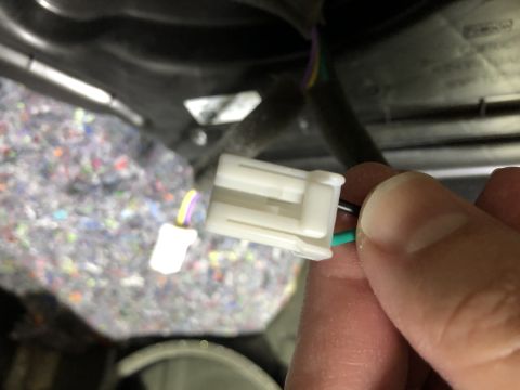 2019 Ford Everest - Close-up of an automotive electrical connector with visible wiring and sound dampening material.