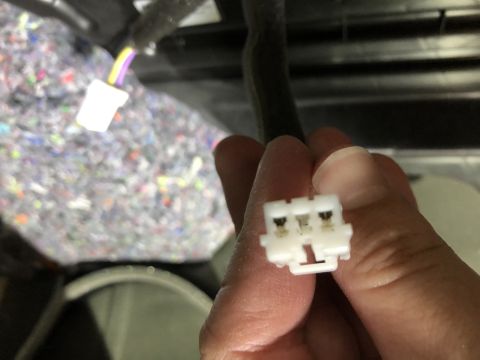 2019 Ford Everest - A white electrical connector with three pins is held in a hand, with wiring visible in the background.