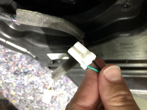 2019 Ford Everest - Close-up of a hand holding a wiring harness connector with visible wires.