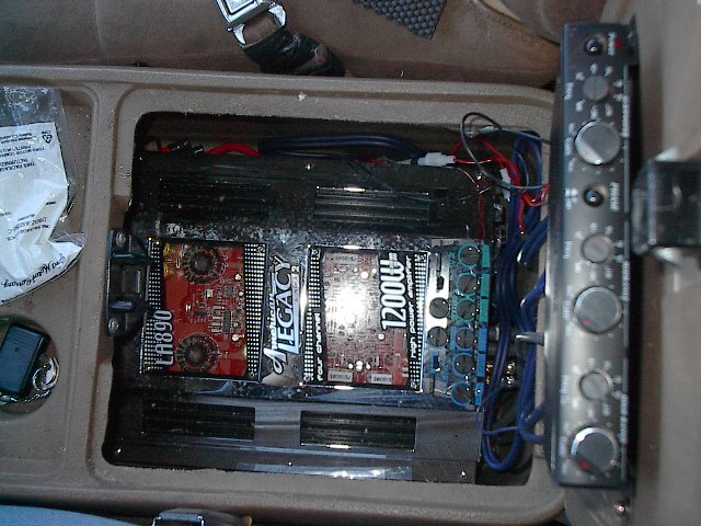 First 4 channel amp is split to power all 4 tweeters. The other half powers both 6 1/2" mid ranger components in doors. Note old tech 6 channel crossover mounted on inside of console lid(out of focus).