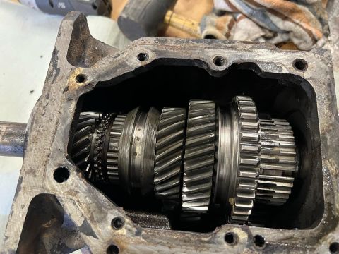 1979 Jeep CJ5 - This is a close-up, overhead view of the internal gears of a manual transmission. The gears are made of metal and are arranged on a shaft w…