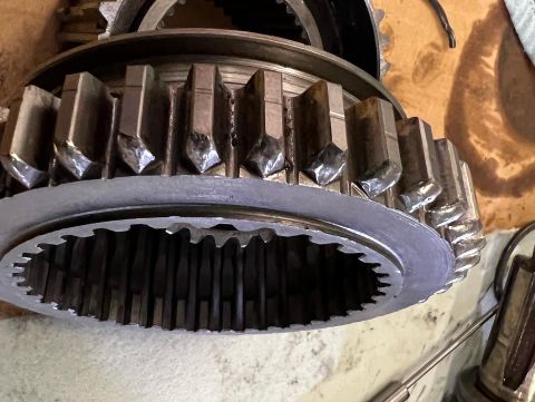 1979 Jeep CJ5 - Close-up of a damaged gear with chipped teeth and a worn ring gear. The gear appears to be part of a transmission or transfer case.