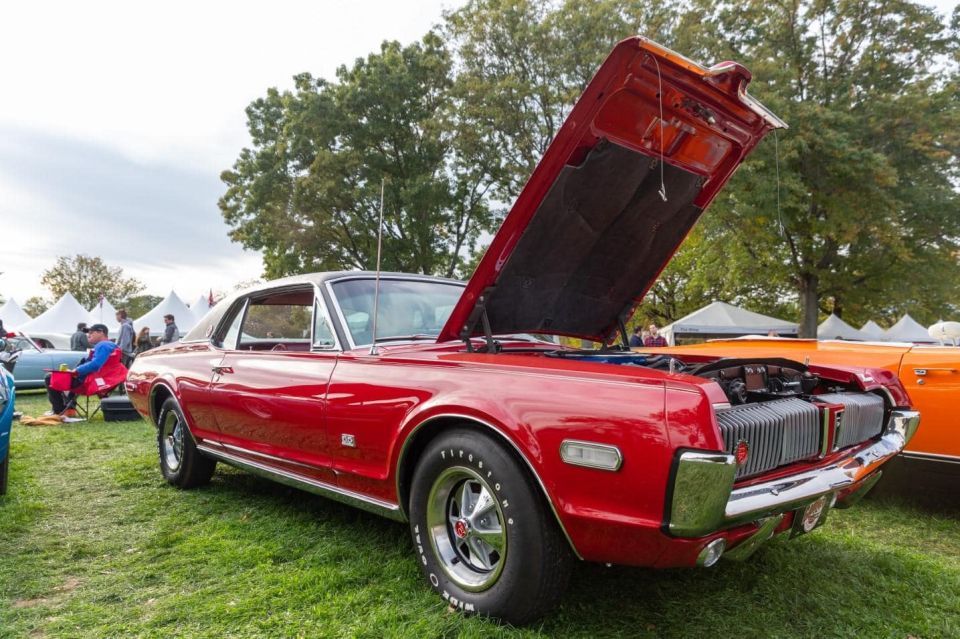 1968 Mercury Cougar XR7-G in red with hood open, parked on grass.