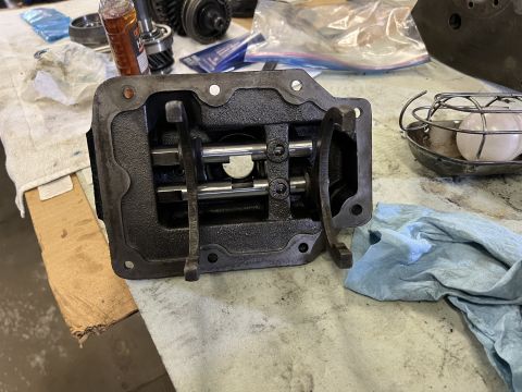1979 Jeep CJ5 - A close-up view of the internal components of a manual transmission shifter housing. The housing is open, revealing two parallel shafts wit…
