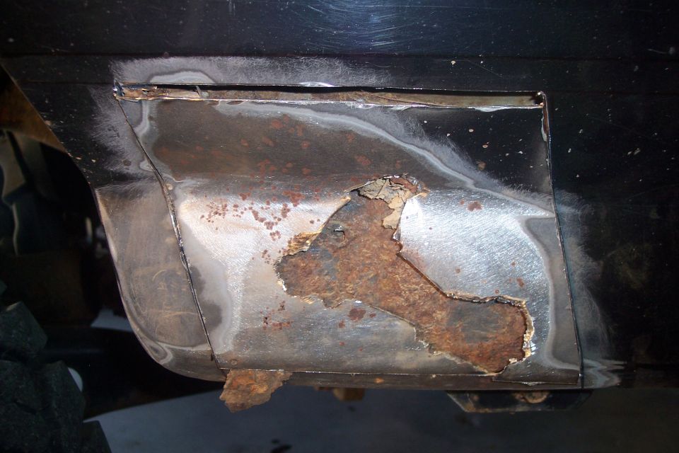 Close-up of rusted and repaired vehicle body panel