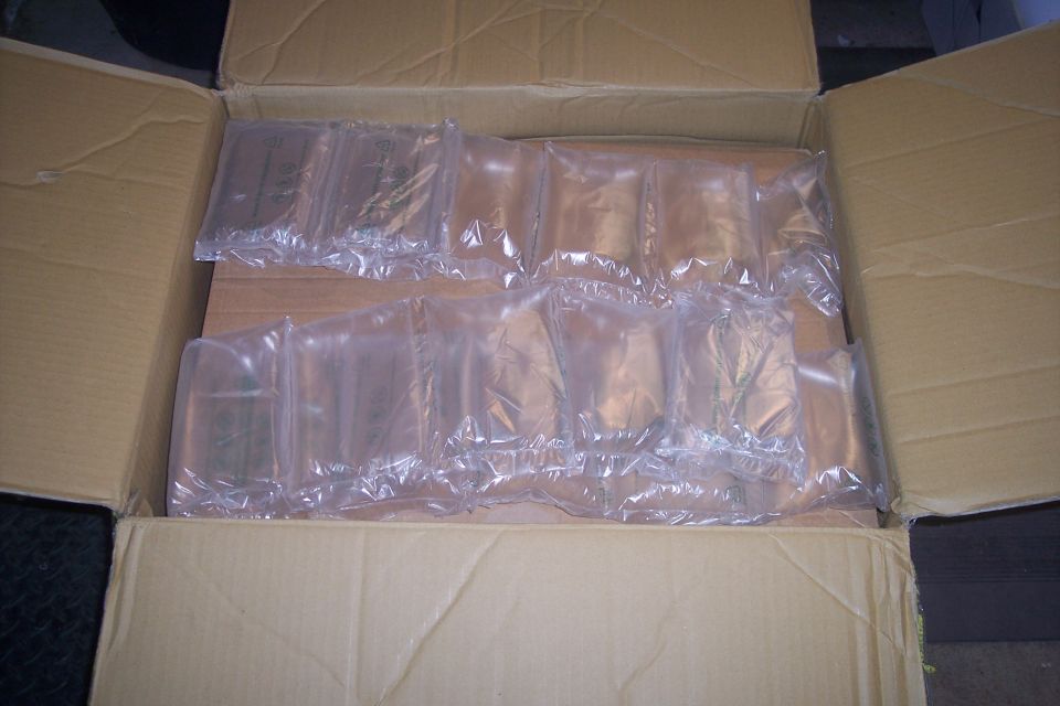 Cardboard box filled with clear plastic air pillows.