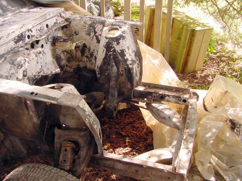 1969 Ford Mustang - The front chassis of a car, showing the engine bay area, is visible in this photo. The vehicle appears to be in a state of disrepair.