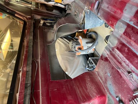 1995 Ford Bronco - Interior view of a vehicle being modified, with a grinder and speaker visible.