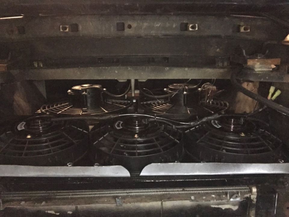Multiple electric fans mounted in front of a radiator