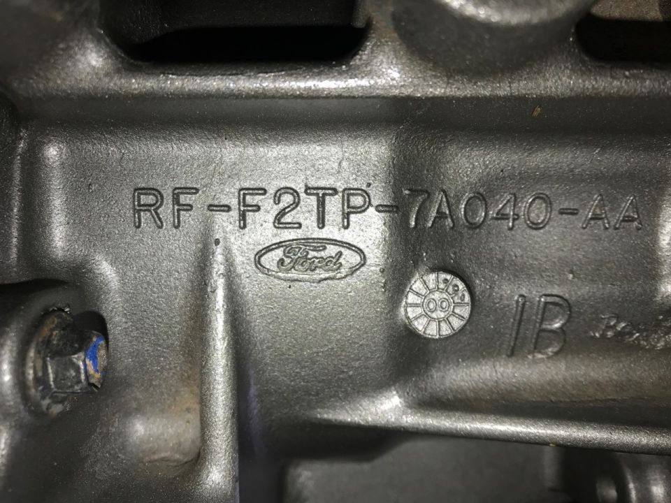 Ford engine part with casting numbers RF-F2TP-7A040-AA and Ford logo