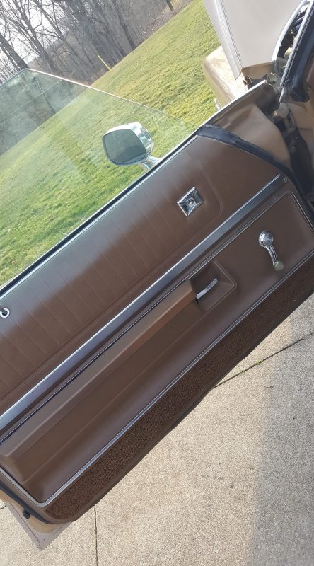 1972 Buick LeSabre - Interior door panel of a 1972 Buick LeSabre, showing brown upholstery and chrome accents.