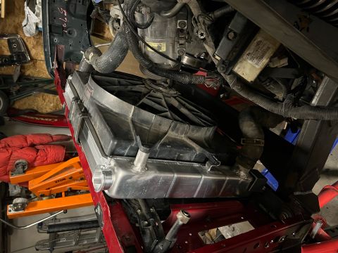 1995 Ford Bronco - Close-up view of a vehicle's radiator and fan assembly, showing engine components and wiring.