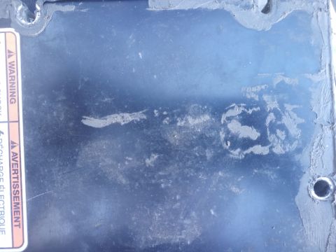 2001 Ford Excursion - A close-up view of a vehicle part with a warning label and some wear and tear.