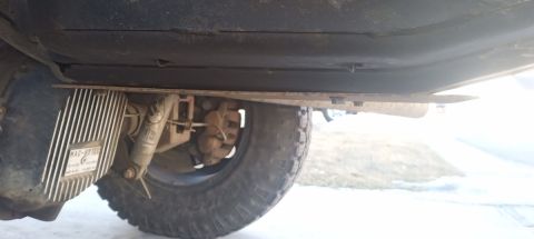 2001 Ford Excursion - Underside view of a vehicle's rear differential, a Mag-Hytec cover and visible shock absorber.