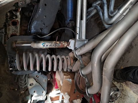 1996 Ford Bronco - Underside view of vehicle suspension and exhaust system components.