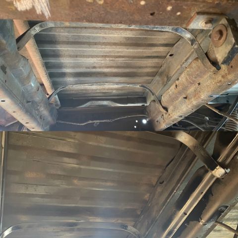 1978 Ford Bronco - Undercarriage of a vehicle, showing fuel tank straps and frame. The image has a watermark for SUPERMOTORS.NET.