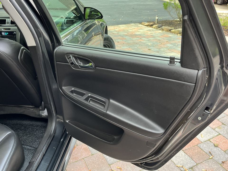Interior door panel and window of a dark-colored car