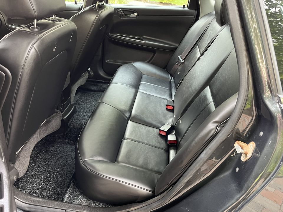 Interior view of a sedan's rear seats and floor mats
