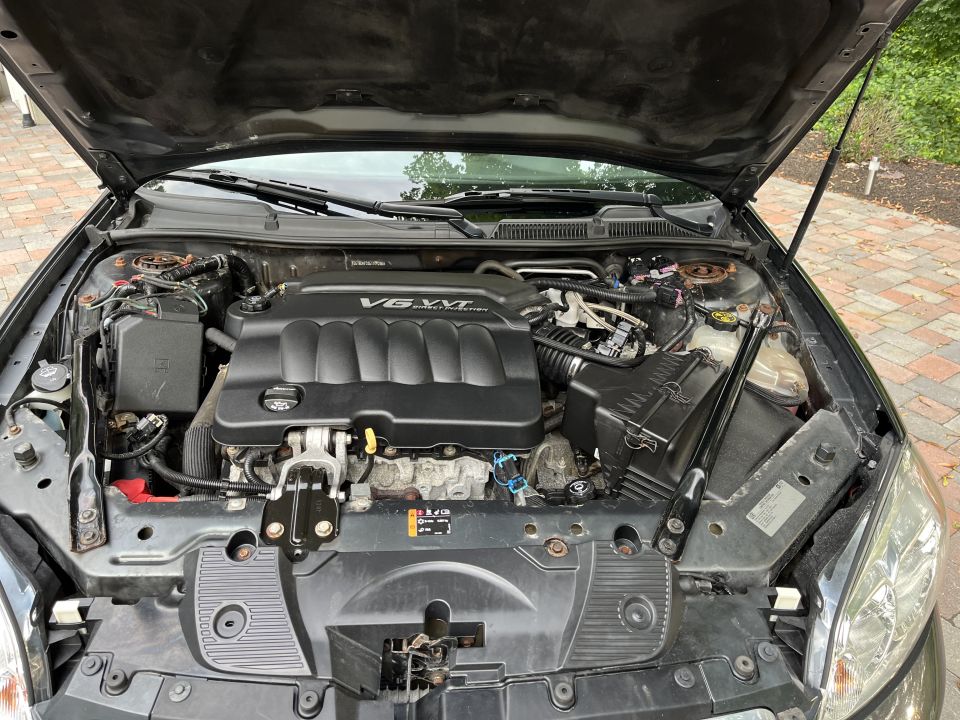 Close-up of a car engine bay with the hood open.