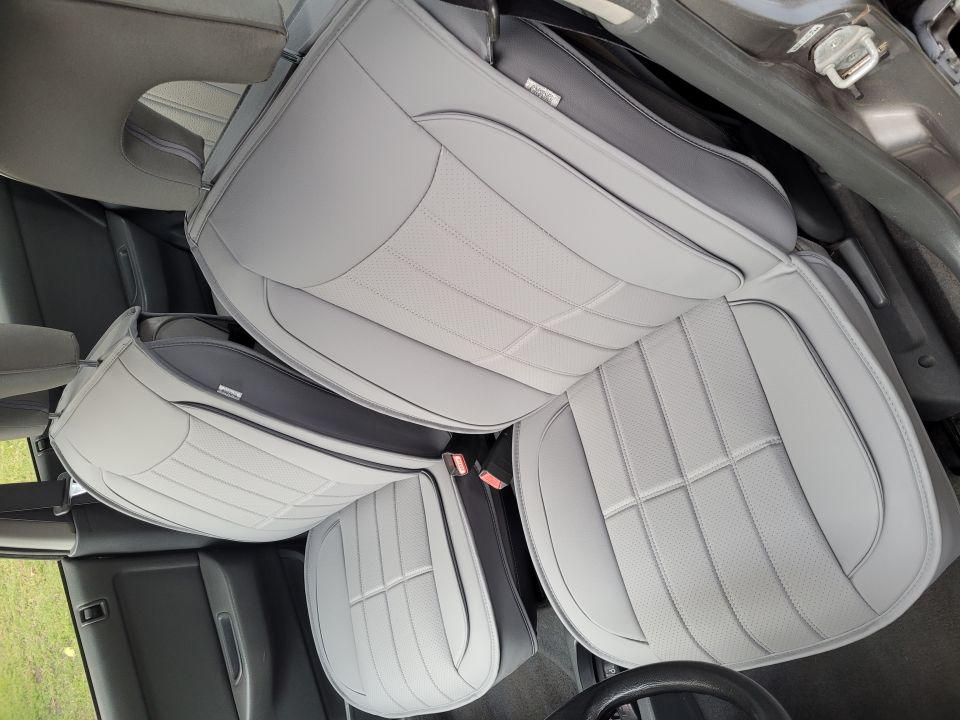 Light gray quilted seat covers installed in a vehicle interior.